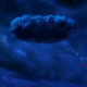 A stream of banners dangles from an ominously shaped cloud in the poster for Nope.